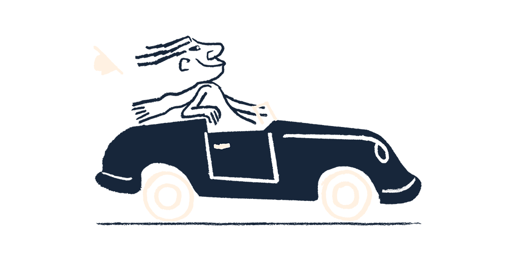 A man driving a car with the wind in his hair